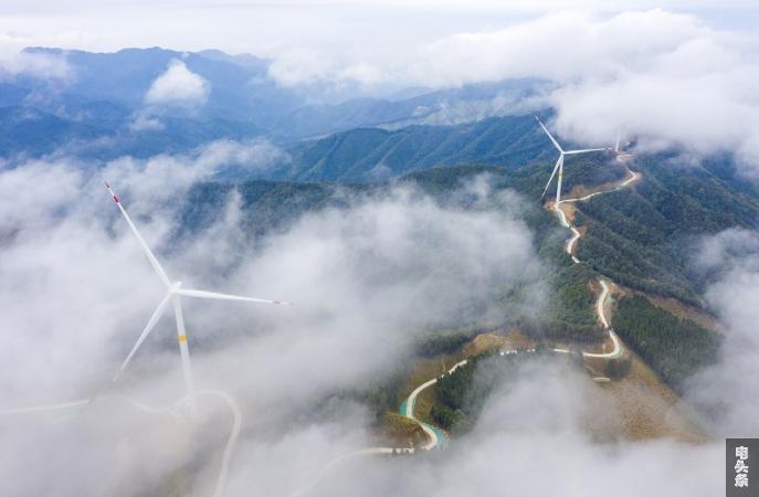 2、2021年12月31日，俯瞰广西梧州苍梧县六堡镇华润风电场，风力发电机组矗立山脊之上，迎风旋转，产生源源不断的绿色电能，助力新能源发展。（何华文）
